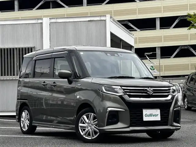 スズキ ソリオ HV MX 静岡県 2024(令6)年 0.7万km タフカーキパールメタリック ユーザー買取車両/ワンオーナー/純正ナビ/　【CD/DVD/BT/地デジフルセグTV】/純正LEDヘッドライト/純正15インチAW/衝突被害軽減システム/車線逸脱警報/レーダークルーズコントロール/全方位カメラ/ビルトインETC/前席シートヒーター/ドライブレコーダー/片側パワースライドドア/USBポート/新車時保証書/取扱説明書/スペアキー×1