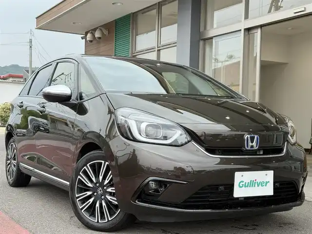 ホンダ フィット e:HEVリュクス 香川県 2020(令2)年 3.6万km プレミアムグラマラスブロンズP 純正8インチSDナビ/フルセグ/CD/DVD/Bluetooth/バックカメラ/純正16インチアルミ/LEDヘッドライト/ホンダセンシング/レーダークルーズコントロール/コーナーセンサー/ハーフレザーシート/前席シートヒーター/ドライブレコーダー/ハンドルヒーター/置くだけ充電/ETC