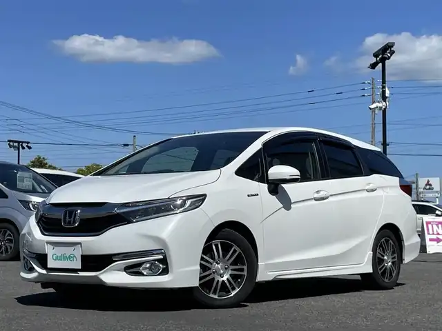 ホンダ シャトル ハイブリッド X ホンダセンシング 栃木県 2018(平30)年 6万km ホワイトオーキッドパール ワンオーナー/社外メモリナビ/　AM/FM/SD/DVD/BT/フルセグ/ホンダセンシング/衝突被害軽減ブレーキ/横滑り防止装置/アダプティブクルーズコントロール/レーンキープ/バックカメラ/ビルトインETC/ドライブレコーダー/アイドリングストップ/ECOMODE/Sモード/シートヒーター/ハーフレザー/革巻きステアリング/ステアリングリモコン/パドルシフト/MTモード付AT/レーダー探知機/プッシュスタート/スマートキー/LEDヘッドライト/オートライト/フォグランプ/電動格納ミラー/ウィンカーミラー/純正フロアマット/ドアバイザー/スペアキー