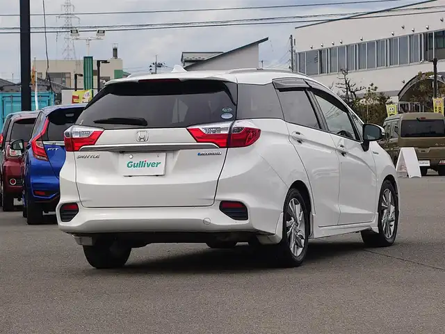 ホンダ シャトル ハイブリッド Z 山形県 2015(平27)年 7.3万km ホワイトオーキッドパール シティブレーキアクティブシステム/純正SDナビ/　　【CD DVD BT フルセグ USB AUX】/バックカメラ/クルーズコントロール/LEDオートヘッドライト/ハーフレザーシート/シートヒーター/純正16インチアルミホイール/ドライブレコーダー/アイドリングストップ/ステアリングスイッチ/パドルシフト/電動格納ウィンカーミラー/フォグランプ/スマートキー×2/ETC