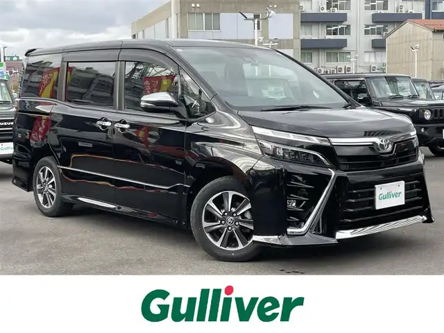 トヨタ ヴォクシー ZS 煌Ⅱ 島根県 2021(令3)年 2.7万km ブラック 社外９型メモリナビ　/フルセグTV　/ＤＶＤ再生　/Ｂｌｕｅｔｏｏｔｈ接続　/ＥＴＣ　/前後ドライブレコーダー　/両側パワースライドドア　/クルーズコントロール　/衝突軽減ブレーキ　/アイドリングストップ/レーンキープアシスト/前後コーナーセンサー　/オートハイビーム／ライト/純正LEDヘッドライト　/純正１６インチアルミホイール/純正フロアマット
