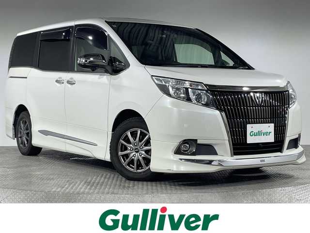トヨタ エスクァイア Gi ブラックテーラード 神奈川県 2016(平28)年 8.4万km ホワイトパールクリスタルシャイン ツインムーンルーフ　/モデリスタエアロ　/純正9インチSDナビ　(NSZT-Y64T)　/‐フルセグTV/AM/FM/CD/DVD/Bluetooth　/バックカメラ　/トヨタセーフティセンス　/プリクラッシュセーフティ　/レーンディパーチャーアラート　/オートマチックハイビーム　/先行車発進告知　/クルーズコントロール　/前後ドラレコ　/前席シートヒーター　/フォグランプ　/社外テールランプ