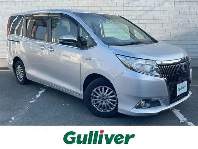 トヨタ エスクァイア ハイブリッド Gi 愛知県 2014(平26)年 6.5万km シルバーM ・純正Tコネクト9インチメモリーナビ/・フルセグテレビ/・CD/DVD再生機能/・Bluetooth接続機能/・ミュージックサーバー（SD録音機能）/・DSRC（ETC）/・バックカメラ/・フリップダウンモニター/・両側電動スライドドア/・合成皮革シート/・3列シート/・純正フロアマット/・純正15インチアルミホイール/・純正LEDヘッドライト/・オートライト/・コムテックドライブレコーダー（前方向）/・スマートキー/・全席オートエアコン/・クルーズコントロール