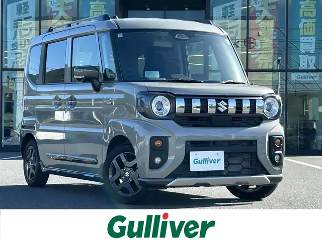 スズキ スペーシア ギア HYBRID XZ 岡山県 2024(令6)年 1.4万km モスグレーメタリック 登録時走行距離13984km/純正9インチナビ/フルセグTV(AM.FM.CD.DVD.TV.BT)/両側パワースライドドア/全方位カメラ/シートヒーター/ステアリングヒーター/クリアランスソナー/衝突軽減ブレーキ/横滑り防止装置/レーダークルーズコントロール/レーンキープアシスト/プッシュスタート/オートライト/オートマチックハイビーム/アイドリングストップ/14インチ純正AW