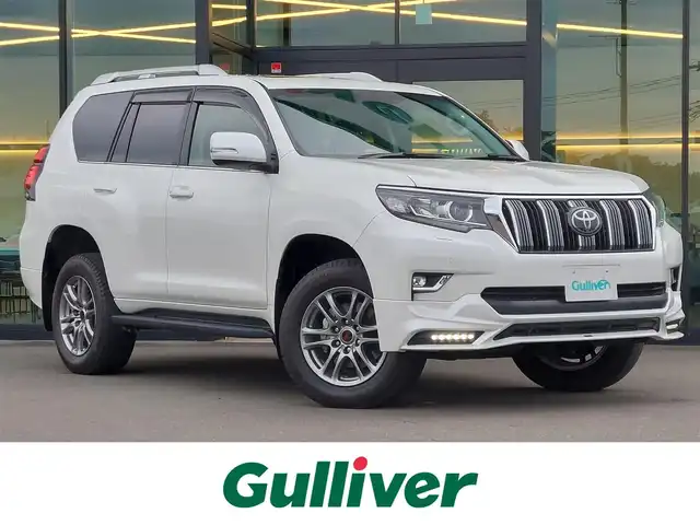 トヨタ ランドクルーザー プラド TX Lパッケージ 東京都 2019(令1)年 1.6万km ホワイトパールクリスタルシャイン サンルーフ/TRDエアロ/TRD18インチAW/ルーフレール/社外メモリナビ/バックカメラ/ビルトインETC/レーダークルーズコントロール/トヨタセーフティセンス/コーナーセンサー/レザーシート/パワーシート/シートヒーター/ベンチレーションシート/LEDヘッドライト/オートマチックハイビーム