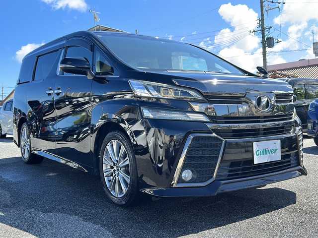 トヨタ ヴェルファイア Z Aエディション ゴールデンアイズ 沖縄県 2016(平28)年 4.9万km バーニングブラッククリスタルシャインガラスフレーク 純正ナビ/（CD/DVD/BT/フルセグTV）/純正フリップダウンモニター/クルーズコントロール/両側パワースライドドア/ハーフレザーシート/オットマン/ビルトインETC/AC100V/純正ドライブレコーダー/純正フロアマット/純正AW/MTモード付AT/スマートキー/プッシュスタート