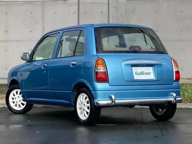 ダイハツ ミラ ジーノ 静岡県 2002(平14)年 8.7万km ライトブルー 社外ディスプレイオーディオ(FH-780DVD)/　AM FM CD DVD/本木製/革巻きステアリング/丸型ハロゲンヘッドランプ/ベージュチェック柄ファブリックシート/純正フロアマット/リモコンキー/スペアキー有/マニュアルエアコン/取扱説明書/ブラウン木目調センターパネル/13インチ白アルミホイール