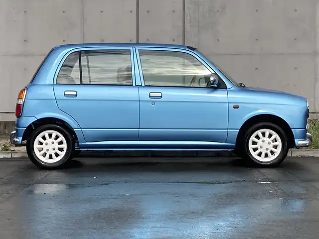 ダイハツ ミラ ジーノ 静岡県 2002(平14)年 8.7万km ライトブルー 社外ディスプレイオーディオ(FH-780DVD)/　AM FM CD DVD/本木製/革巻きステアリング/丸型ハロゲンヘッドランプ/ベージュチェック柄ファブリックシート/純正フロアマット/リモコンキー/スペアキー有/マニュアルエアコン/取扱説明書/ブラウン木目調センターパネル/13インチ白アルミホイール