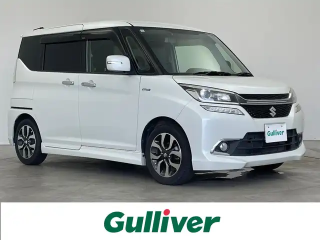 スズキ ソリオ バンディット HV MV 埼玉県 2017(平29)年 4.3万km ピュアホワイトP 純正ナビ（8インチ）/→Bluetooth、CD、DVD、SD、USB、TV、ipod/両側パワースライドドア/デジタルインナーミラー/ドライブレコーダー（前後）/シートヒーター（前席のみ）/ビルトインETC/LEDヘッドライト/スリムサーキュレーター/デュアルセンサーサポートブレーキ/誤発進抑制機能/発進お知らせ機能/低速時ブレーキサポート（前進・後退）/パーキングセンサー/車線維持支援機能/車線逸脱抑制機能/ふらつき警報機能/標識認識機能