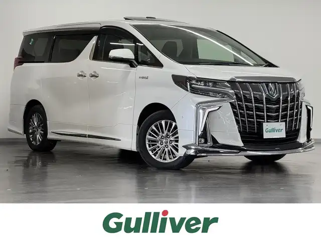 トヨタ アルファードハイブリット SR Cパッケージ 三重県 2020(令2)年 4万km ホワイトパールクリスタルシャイン ハイブリッド/E-Four（4WD）/MTモード付インパネCVT/JBLプレミアムサウンド*/純正10.5インチナビ/（FM/AM/CD/DVD/Blu-ray/SDREC/SD/USB/Bluetooth/VTR/HDMI/TV/AUX/Miracast/CarPlay/AndroidAuto）/13.3インチ 後席モニター*/パノラミックビューモニター*/モデリスタエアロ（F/S/R下）/両側パワースライドドア/ドライブレコーダー 前方/ビルトイン ETC2.0/Toyota Safety Sense/・PCS/・LTA/・【OP】BSM & RCTA*1/・パーキングサポートブレーキ（静止物・後方接近車両）/・アダプティブハイビームシステム/・レーダークルコン/・ロードサインアシスト/・インテリジェントパーキングアシスト*/など/装備/・ツインムーンルーフ*/・デジタルインナーミラー*1/・合皮シート/・パワーシート（D/N）/・エグゼクティブパワーシート（電動リクライニング＆オットマン）/・パワーバックドア/・シートヒーター、ベンチレーション（D/N）/・ステアリングヒーター/・左右＆後席独立オートエアコン/・おくだけ充電*/・3眼LEDヘッドランプ/・スマートキーx2/・保/取/ナビ取/など/*メーカーOP