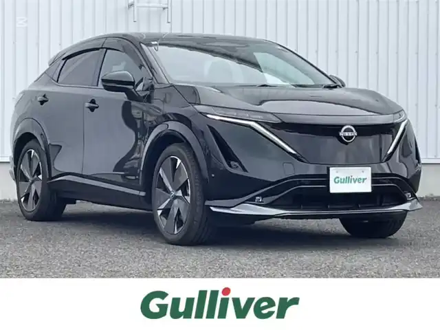 日産 アリア B9 e－4ORCE プレミア 熊本県 2024(令6)年 0.2万km パープル カラーコード：DAP（ミッドナイトパープル）/純正ナビ/・AM/FM/HDMI/BT/・AppleCarPlay/AndroidAuto/・フルセグTV/全周囲カメラ/・フロント/バック/サイド/プロパイロット/衝突防止支援/踏み間違い防止支援/後側方車両検知支援/後側方車両衝突防止支援/車両逸脱警報/車両逸脱防止支援/駐車支援/オートマチックハイビーム/純正革巻きステアリング/・ステアリングスイッチ/レザーシート/・D/N席パワーシート/・D/N席シートヒーター/・全席シートヒーター/オートライト/・LEDライト/・フォグランプ/デジタルインナーミラー/電動アームレスト/サンルーフ/ETC2.0/BOSEプレミアムサウンド/前後ドライブレコーダー/電動格納ミラー/・ウィンカーミラー/e-pedal/置くだけ充電/電動サイドブレーキ/・オートホールドボタン/パワーバックドア/フルエアロ/純正ドアバイザー/純正アルミホイール/純正フロアマット/スマートキー/・スペアキー
