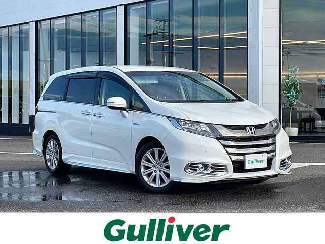ホンダ オデッセイ ハイブリッド アブソルートセンシングEXパック 新潟県 2016(平28)年 10.4万km ホワイトオーキッドパール ワンオーナー/純正HDDナビ/〈BT／FM／AM／DVD〉/純正後方モニター/全方位カメラ/社外アルミホイール　MODURO/黒本革レザーシート/パワーシート〈運転席〉/シートヒーター〈運転席＋助手席〉/エアシート〈運転席＋助手席〉/全席パワーウィンドウ/クルーズコントロール/衝突軽減ブレーキ/両側パワースライド/レーンアシストキープ/100V充電/ビルトインETC/LEDライト/オートライト/スペアキー/カーテンエアバック/USB入力端子/ドアバイザー