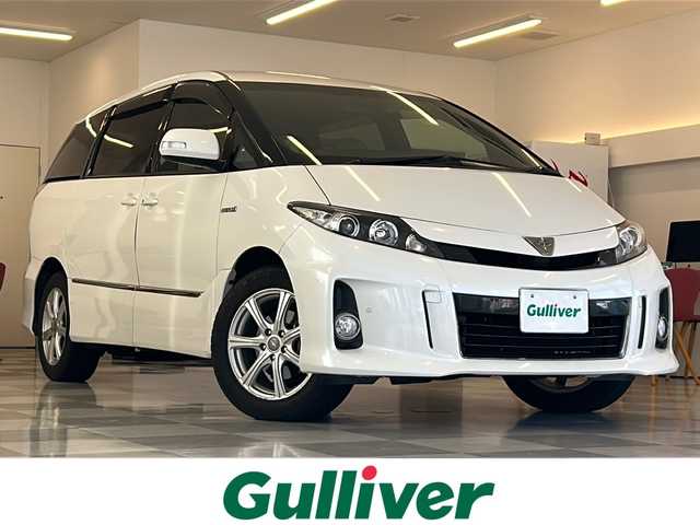 トヨタ エスティマ ハイブリッド アエラス ベリーエディション 岐阜県 2015(平27)年 7.6万km ホワイトパールクリスタルシャイン 純正8型ナビゲーション(NSZA-X64T)/Bluetooth/フルセグ/バックモニター/Wエアコン/両側電動スライドドア/レザーシート/前席シートヒーター/パワーシート/オットマン/ドライブレコーダー/クルーズコントロール/クリアランスソナー/HIDヘッドライト/オートライト/プッシュスタート/スマートキー/スペアキー/４WD/AC１００V/純正アルミ4本積み込みあり
