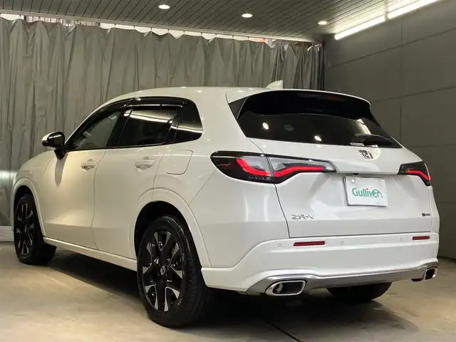 ホンダ ＺＲ－Ｖ ハイブリッド e:HEV Z 東京都 2022(令4)年 2.1万km プラチナホワイトパール ホンダセンシング/・衝突軽減ブレーキ/・ブラインドスポットモニター/・追従式クルーズコントロール/・先行車発進お知らせ機能/・誤発進抑制機能/・後方誤発進抑制機能/・渋滞追従機能付きアダクティブクルーズコントロール/BOSEサウンド/純正ナビ/（ラジオ/BT/USB/フルセグ）/全方位カメラ/ビルトインETC2.0/LEDヘッドライト/D/N席パワーシート/運転席シートメモリー/パドルシフト/オートブレーキホールド/置くだけ充電/スペアキー/保証書あり/取扱説明書あり（車両・ナビ）