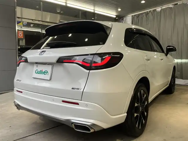 ホンダ ＺＲ－Ｖ ハイブリッド e:HEV Z 東京都 2022(令4)年 2.1万km プラチナホワイトパール ホンダセンシング/・衝突軽減ブレーキ/・ブラインドスポットモニター/・追従式クルーズコントロール/・先行車発進お知らせ機能/・誤発進抑制機能/・後方誤発進抑制機能/・渋滞追従機能付きアダクティブクルーズコントロール/BOSEサウンド/純正ナビ/（ラジオ/BT/USB/フルセグ）/全方位カメラ/ビルトインETC2.0/LEDヘッドライト/D/N席パワーシート/運転席シートメモリー/パドルシフト/オートブレーキホールド/置くだけ充電/スペアキー/保証書あり/取扱説明書あり（車両・ナビ）