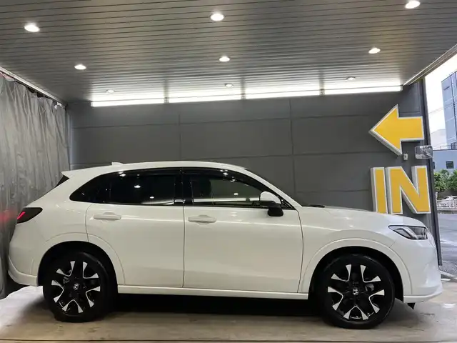 ホンダ ＺＲ－Ｖ ハイブリッド e:HEV Z 東京都 2022(令4)年 2.1万km プラチナホワイトパール ホンダセンシング/・衝突軽減ブレーキ/・ブラインドスポットモニター/・追従式クルーズコントロール/・先行車発進お知らせ機能/・誤発進抑制機能/・後方誤発進抑制機能/・渋滞追従機能付きアダクティブクルーズコントロール/BOSEサウンド/純正ナビ/（ラジオ/BT/USB/フルセグ）/全方位カメラ/ビルトインETC2.0/LEDヘッドライト/D/N席パワーシート/運転席シートメモリー/パドルシフト/オートブレーキホールド/置くだけ充電/スペアキー/保証書あり/取扱説明書あり（車両・ナビ）
