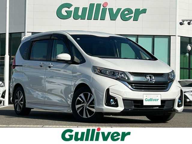 ホンダ フリード＋ ハイブリット EX 佐賀県 2016(平28)年 7.9万km ホワイトオーキッドパール ワンオーナー/純正7型ワイドナビ(フルセグTV/AM/FM/BT/USB/HDMI)/ホンダセンシング/衝突軽減ブレーキ/誤発進抑制/アダプティブクルーズコントロール/車線維持支援/歩行者事故低減ステアリング/先行者発進お知らせ/標識認識/バックカメラ/両側パワースライドドア/ビルトインETC/ハーフレザーシート(合皮)/シートヒーター(D/N席)/ロールサンシェード(2列目)/LEDヘッドライト/フォグランプ/フロントワイパーデアイサー/Moduloサイドエアロ/現状サマー(純正AW)(185/65/R15)/社外15インチアルミ4本積込(スタッドレス付)/スマートキー×2本/保証書、取扱説明書/DUNLOP ENASAVE RV505/BRIDGESTONE BLIZAK VRX2