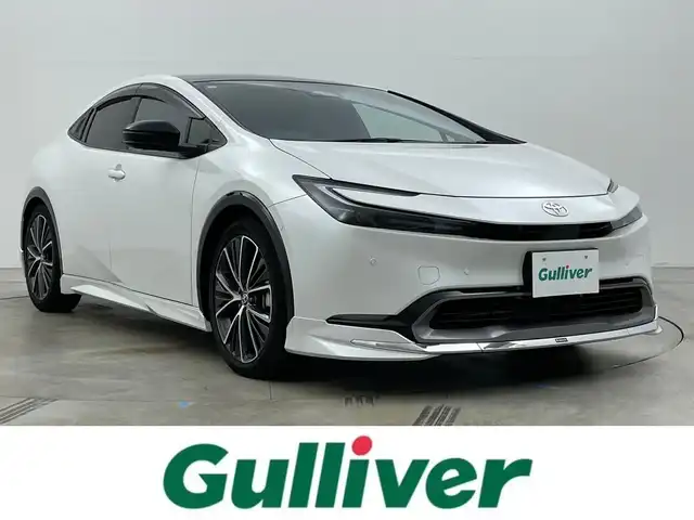 トヨタ プリウス Z 岡山県 2025(令7)年 0.9万km プラチナホワイトパールマイカ ガラスルーフ/モデリスタフルエアロ/純正12.3インチナビ /地デジ/BT/AppleCarPlay/USB/パノラミックビューモニター/ビルトインETC2.0/黒合皮シート/シートヒーター /ベンチレーション/レーダークルーズコントロール/ステアリングヒーター/BSM/デジタルインナーミラー/純正前後ドラレコ /シートメモリー/純正フロアマット/LEDヘッドライト