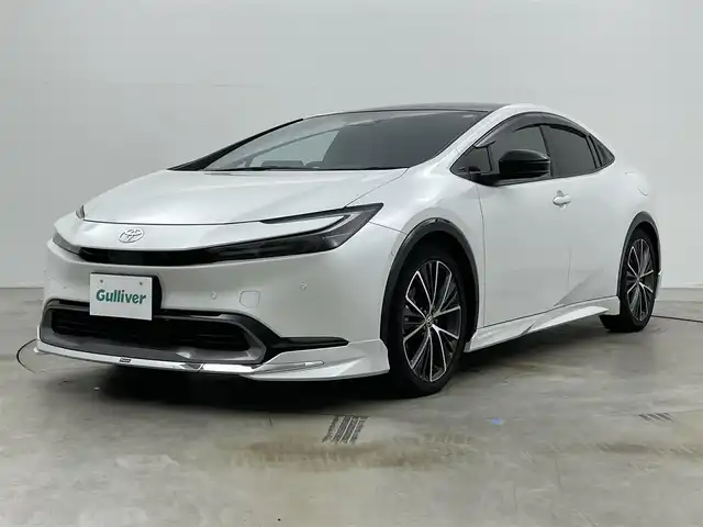 トヨタ プリウス Z 岡山県 2025(令7)年 0.9万km プラチナホワイトパールマイカ ガラスルーフ/モデリスタフルエアロ/純正12.3インチナビ /地デジ/BT/AppleCarPlay/USB/パノラミックビューモニター/ビルトインETC2.0/黒合皮シート/シートヒーター /ベンチレーション/レーダークルーズコントロール/ステアリングヒーター/BSM/デジタルインナーミラー/純正前後ドラレコ /シートメモリー/純正フロアマット/LEDヘッドライト