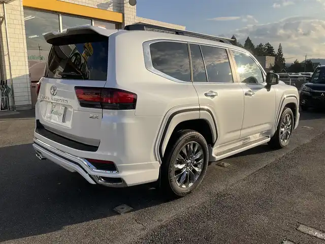 トヨタ ランドクルーザー ZX 滋賀県 2025(令7)年 0.1千km プレシャスホワイトパール ワンオーナー/車検10年9月まで/モデリスタエアロ（フロント、サイド、リア）/3列シート7人乗り/ブラックルーフレール/クールボックス/トノカバー/ムーンルーフ/タイヤ空気圧警報システム/トヨタセーフティセンス/ブラインドスポットモニター/レーダークルーズコントロール/12.3インチディスプレイオーディオプラス/フルセグテレビ、AppleCarPlay、AndroidAuto/JBLプレミアムサウンドシステム/後席11.6インチリアシートエンターテインメント/パノラミックビューモニター/ビルトインETC2.0/ベージュ革シート/前席パワーシート/前席、2列目ベンチレーション付き快適温熱シート/スペアキー有り/取扱説明書、保証書/