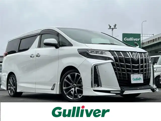 トヨタ アルファード S Cパッケージ 愛知県 2018(平30)年 5.9万km ホワイトパールクリスタルシャイン 〇純正9型ナビ/・Bluetooth/・フルセグTV/〇パワースライドドア（両側）/〇ツインムーンルーフ/〇TRDエアロ/〇電動リアゲート/〇バックカメラ/〇ビルトインETC2.0/〇ドライブレコーダー/〇後席用フリップダウンモニター/〇全車速追従機能付クルーズコントロール/〇レーンアシスト/〇衝突軽減装置/〇クリアランスソナー/〇LEDヘッドランプ/〇フォグランプ/〇オートライト/〇デュアルオートエアコン/〇革巻きステアリング/〇ステアリングスイッチ/〇前席/後席2列目パワーシート/〇前席シートヒーター/エアコン/〇社外19インチアルミホイール/〇スマートエントリー/〇禁煙車