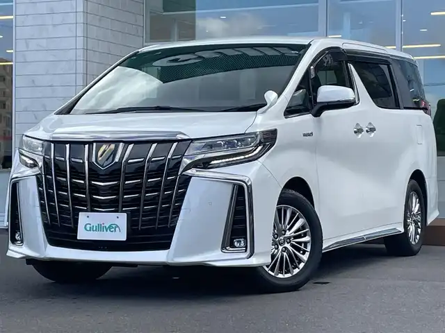 トヨタ アルファードハイブリット S タイプゴールド 道央・札幌 2021(令3)年 9.6万km ホワイトパールクリスタルシャイン ・4WD/・衝突軽減ブレーキ/・寒冷地仕様/・両側パワースライドドア/・純正ナビ/CD&DVD&BT&フルセグTV&AppleCarPlay/・キャンセラー/・ハンズフリー/・フリップダウンモニター(リモコン付)/・バックカメラ/・コーナーセンサー/・レーンキープアシスト/・レーダークルーズコントロール(追従走行あり)/・横滑り防止装置/・WAC/・前席バニティミラー(両側ライト付)/・ウォークスルー/・2列目両側オットマン/・USB入力端子/・1列目2列目100V充電/・プッシュスタート/・スマートキー/・ワイパー熱線/・前方純正ドライブレコーダー/・ビルトインETC/・オートライト/・オートマチックハイビーム/・前後コーナーセンサー/・電動格納ミラー/・ウィンカーミラー/・フォグランプ/・純正フロアマット/・ドアバイザー/・積込17インチ冬タイヤ