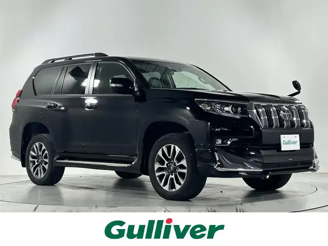 トヨタ ランドクルーザー プラド TX Lパッケージ 佐賀県 2023(令5)年 3万km ブラック 純正9インチナビ/フルセグTV/CD/DVD/Bluetooth/バックカメラ/サンルーフ/モデリスタエアロ/運転席・助手席サイドステップ/衝突被害軽減システム/レーダークルーズコントロール/レーンアシスト/ロードサインアシスト/先行車発進お知らせ機能/オートライト/オートマチックハイビーム/LEDヘッドライト/LEDフォグライト/クリアランスソナー/ビルトインETC/運転席・助手席シートヒーター/運転席・助手席エアシート/運転席・助手席パワーシート/レザーシート/ISOFIX対応/純正19インチアルミホイール/ルーフレール/４WD/純正フロアマット/スマートキー/スペアキー×１