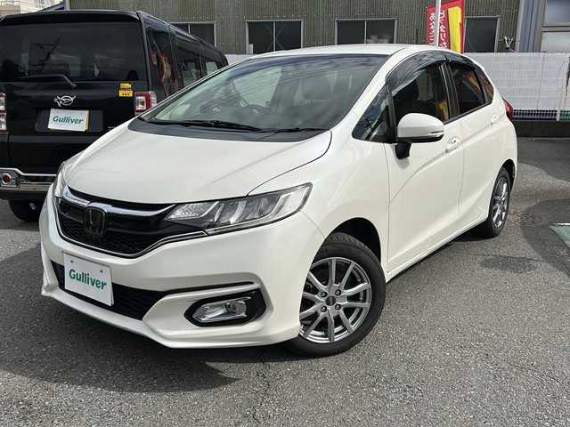ホンダ フィット 13G L ホンダセンシング 埼玉県 2018(平30)年 5.4万km プレミアムホワイトパールⅡ ホンダセンシング/ ・衝突軽減ブレーキ/ ・誤発進抑制機能/ ・車線維持支援システム/ ・先行車発進お知らせ機能/ ・標識認識機能/純正メモリーナビゲーション(VXM-184VFi)/(AM/FM/CD/DVD/BT/USB/フルセグＴＶ)/バックカメラ/社外前後ドライブレコーダー(DRY-TW7550d)/ビルトインＥＴＣ/追従型クルーズコントロール/ＬＥＤヘッドライト/オートライト/フォグランプ/純正フロアマット/ドアバイザー/スペアキー１ヶ/保証書