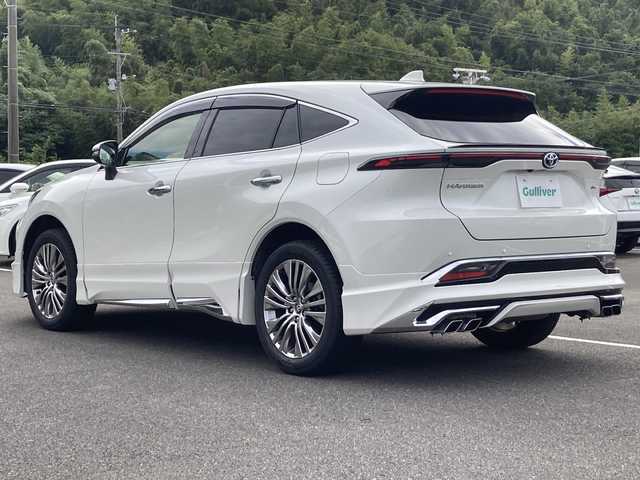 トヨタ ハリアー ハイブリッド Z レザーパッケージ 佐賀県 2021(令3)年 4.4万km ホワイトパールクリスタルシャイン モデリスタエアロ/JBLサウンドシステム/純正12.3インチナビ/パノラマミックビューモニター/プリクラッシュセーフティ/レーンディパーチャーアラート/オートハイビーム/アダプティブクルーズコントロール/ブラインドスポットモニター/クリアランスソナー/リアクロストラフィックアラート/ヘッドアップディスプレイ/デジタルインナーミラー（前方録画機能付き）/電動パーキングブレーキ/オートブレーキホールド/レザーシート/シートヒーター/エアシート/メモリパワーシートシート/ステアリングヒーター/パワーバックドア/ビルトインETC2.0 /プッシュスタート/スマートキー/LEDヘッドライト/フォグライト/純正アルミホイール/社外シーケンシャルウィンカー（リア）