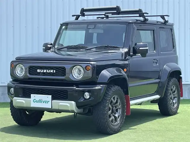 スズキ ジムニー シエラ JC 香川県 2020(令2)年 6.9万km ブルーイッシュブラックパール3 登録時走行距離：68303km/パナソニック製8型ナビ/　CD DVD BT フルセグTV/バックカメラ/ビルトインETC/ドライブレコーダー/衝突被害軽減装置/レーンキープアシスト/クルーズコントロール/ダウンヒルアシストコントロール/LEDヘッドライト/オートライト/フォグランプ/ヘッドライトウォッシャー/純正マッドガード/ルーフキャリア/背面タイヤ/電動格納ミラー/ヒーテッドドアミラー/純正革調シートカバー/シートヒーター/プッシュスタート/スマートキー/スペアキー