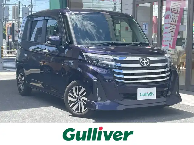 トヨタ ルーミー カスタムG 愛知県 2021(令3)年 2.2万km クールバイオレットクリスタルシャイン 純正9型SDナビ（NSZT-Y68T）/・DVD/Bluetooth／地デジTV/バックカメラ＋全方位カメラ/両側パワースライドドア/スマートアシスト/・衝突回避支援ブレーキ/・誤発進抑制機能/・先行車発進お知らせ/・ACC（アダプティブクルーズコントロール）/前後コーナーセンサー/ETC/コムテック前後ドラレコ（DC-DR652）/電子パーキング/オートブレーキホールド/後席ロールサンシェード/スマートキー＆プッシュスタート/純正14インチAW