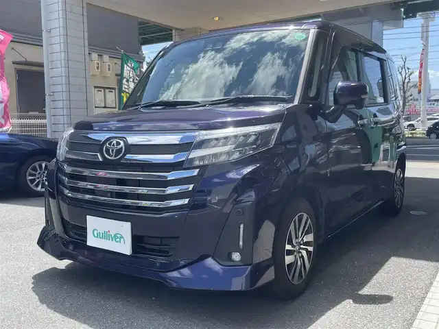 トヨタ ルーミー カスタムG 愛知県 2021(令3)年 2.2万km クールバイオレットクリスタルシャイン 純正9型SDナビ（NSZT-Y68T）/・DVD/Bluetooth／地デジTV/バックカメラ＋全方位カメラ/両側パワースライドドア/スマートアシスト/・衝突回避支援ブレーキ/・誤発進抑制機能/・先行車発進お知らせ/・ACC（アダプティブクルーズコントロール）/前後コーナーセンサー/ETC/コムテック前後ドラレコ（DC-DR652）/電子パーキング/オートブレーキホールド/後席ロールサンシェード/スマートキー＆プッシュスタート/純正14インチAW