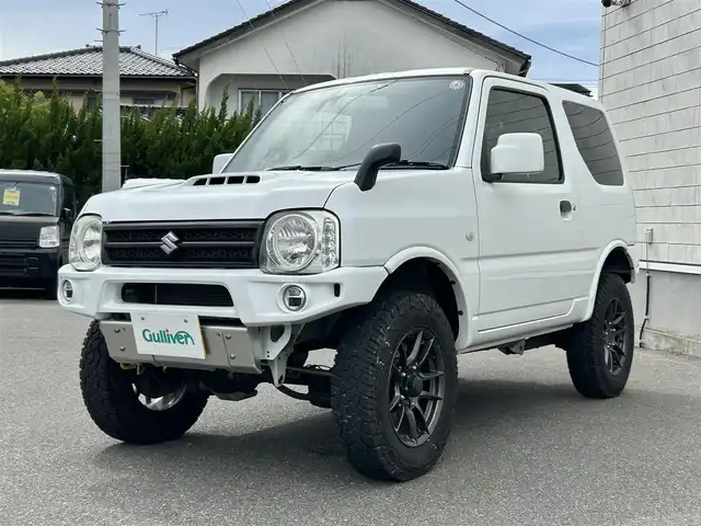 スズキ ジムニー XG 山形県 2014(平26)年 4.5万km スペリアホワイト ４WD/ターボ/フロントカメラ/横滑り防止装置/リフトアップ/社外足廻り/社外FRバンパー/社外マフラー/社外アルミホイール/背面タイヤ/フォグランプ/スペアキー/保証書