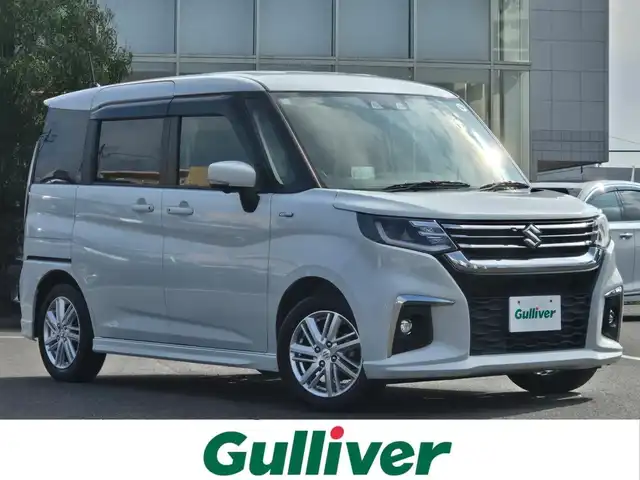 スズキ ソリオ HV MZ 鹿児島県 2021(令3)年 4万km ピュアホワイトP アダプティブクルーズコントロール　/純正オプション１０インチＳＤナビ　/全方位モニター　/Ｂｌｕｅｔｏｏｔｈオーディオ　/フルセグテレビ/カラーヘッドアップディスプレイ　/Ｄ＋Ｎ席シートヒーター　/スズキセーフティサポート/両側パワースライドドア/前後純正ドライブレコーダー/前後コーナーセンサー/横滑り防止装置/レーンキープアシスト/純正アルミホイール(15インチ)/プッシュスタート/スマートキー/エアバッグ(W+サイド)