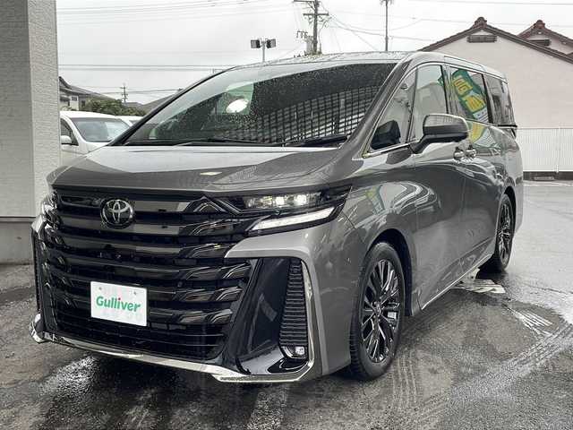 トヨタ ヴェルファイア ハイブリット Z プレミア 愛知県 2025(令7)年 0.1千km グレー ワンオーナー/左右独立ムーンルーフ/トヨタチームメイト/【アドバンストパーク・パーキングサポートブレーキ（周辺静止物）・アドバンストドライブ・緊急時操舵支援・フロントクロストラフィックアラート・レーンチェンジアシスト・ドライバーモニターカメラ】/Toyota Safety Sense/【プリクラッシュセーフティ・レーントレーシングアシスト・全車速追従機能付レーダークルーズコントロール・アダプティブハイビームシステム/・ロードサインアシスト・ドライバー異常時対応システム・プロアクティブドライビングアシスト・発進遅れ告知機能・BSM】/パーキングサポートブレーキ/デジタルインナーミラー/14インチディスプレイオーディオ/【車載ナビ・地デジTV・Mira cast】/ETC2.0/パノラミックビューモニター/ヘッドアップディスプレイ/両側パワースライドドア/パワーバックドア/本革シート/シートヒーター/ベンチレーション/ステアリングヒーター/置くだけ充電/新車保証書/スペアキーあり