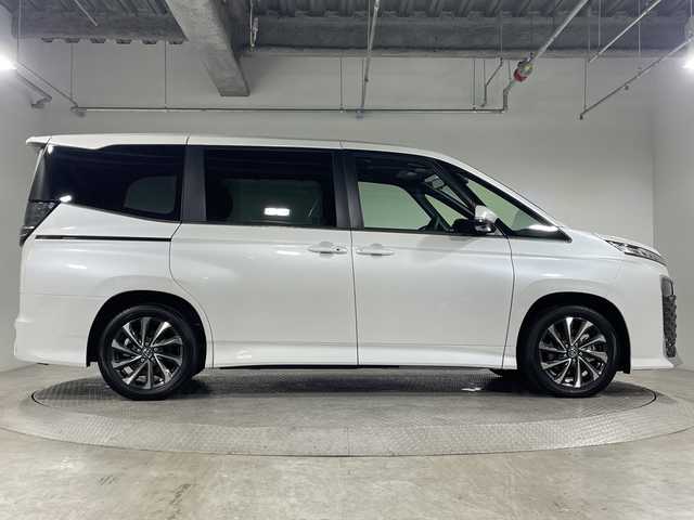 トヨタ ヴォクシー ハイブリッド 神奈川県 2025(令7)年 0.1千km プラチナホワイトパールマイカ ToyotaSafetySense/プリクラッシュセーフティ/緊急時操舵支援/フロントクロストラフィックアラート/レーントレーシングアシスト/レーンディパーチャーアラート/レーダークルーズコントロール/オートマチックハイビームシステム/ロードサインアシスト/ドライバー異常時対応システム/プロアクティブドライビングアシスト/発進遅れ告知機能/パーキングサポートブレーキ/(前後方静止物/後方接近車両)/(周囲静止物/後方歩行者)/アドバンストパーク/パノラミックビューモニター/ECO/PWR+EVモード/８インチディスプレイオーディオ/コネクティッドナビ/DTV/Bluetooth/スマホ連携/HDMI/快適便利パッケージ/ハンズフリーデュアルパワースライドドア/パワーバックドア/ステアリングヒーター/シートヒーター(前席・2列目)/オットマン/デジタルインナーミラー/AC100Vコンセント/ブレーキホールド/取説/ナビ説/保証書/スペアキー