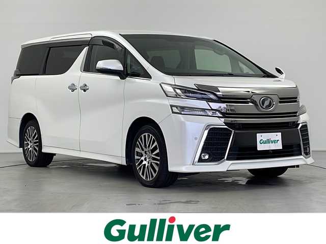 トヨタ ヴェルファイア ZA Gエディション 岐阜県 2016(平28)年 9.3万km ホワイトパールクリスタルシャイン 純正9インチナビ/　(AM/FM/CD/DVD/Bluetooth/フルセグTV)/バックカメラ/衝突軽減ブレーキ/レーンキープアシスト/コーナーセンサー/レーダークルーズコントロール/オートハイビーム/両側パワースライドドア/パワーバックドア/レザーシート/パワーシート/シートヒーター/メモリシート/オットマン/ステアリングヒーター/ウッドコンビステアリング/ドライブレコーダー/ビルトインETC/純正アルミホイール/社外フロアマット