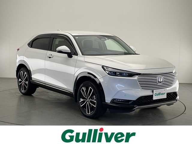ホンダ ヴェゼル ハイブリッド e:HEV Z 宮崎県 2022(令4)年 2.1万km プラチナホワイトパール ワンオーナー/Honda SENSING/ブラインドスポットインフォメーション/コーナーセンサー/純正9インチSDナビ/フルセグTV/CD/DVD/Music Rack/Bluetooth/バックカメラ/コンビシート/レザー調シートカバー/シートヒーター/ハンズフリーアクセスパワーテールゲート(予約クローズ機能付)/LEDヘッドライト/純正18インチAW/ビルトインETC/保証書