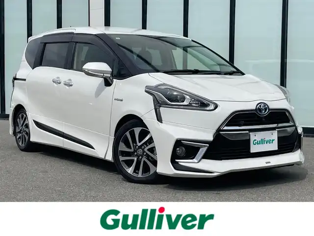 トヨタ シエンタ ハイブリッド G 大阪府 2015(平27)年 6.9万km ホワイトパールクリスタルシャイン 純正メモリナビ/・CD/DVD/BT/フルセグ/モデリスタフルエアロ/両側パワースライドドア/革調シートカバー/シートヒーター/ドライブレコーダー/ビルトインＥＴＣ/衝突軽減ブレーキ/レーンキープアシスト/ＬＥＤライト/純正アルミ/ダウンサス（純正車載）/革巻きステアリング