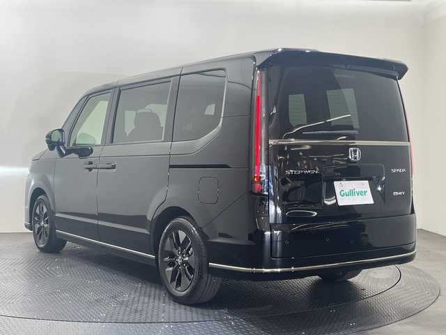 ホンダ ステップワゴン スパーダ eHEV 愛媛県 2025(令7)年 0.1千km クリスタルブラックパール 11.4インチナビHonda CONNECTナビ/Bluetooth/フルセグテレビ/バックカメラ/Honda CONNECT for Gathers/ナビ装着用スペシャルパッケージ/Honda SENSING/ブラインドスポットインフォメーション/パワーテールゲート(メモリー機能付)/2列目オットマン/ハーフレザーシート/運転席＆助手席シートヒーター/トリプルゾーンコントロール/フルオートエアコンディショナー/コンビシート/16インチアルミホイール(SPADA専用)/減速セレクター/全列USBチャージャー/LEDヘッドライト/両側パワースライドドア/スマートキー/追従型クルーズコントロール/前後コーナーセンサー