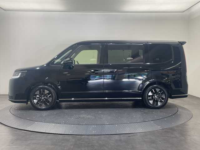 ホンダ ステップワゴン スパーダ eHEV 愛媛県 2025(令7)年 0.1千km クリスタルブラックパール 11.4インチナビHonda CONNECTナビ/Bluetooth/フルセグテレビ/バックカメラ/Honda CONNECT for Gathers/ナビ装着用スペシャルパッケージ/Honda SENSING/ブラインドスポットインフォメーション/パワーテールゲート(メモリー機能付)/2列目オットマン/ハーフレザーシート/運転席＆助手席シートヒーター/トリプルゾーンコントロール/フルオートエアコンディショナー/コンビシート/16インチアルミホイール(SPADA専用)/減速セレクター/全列USBチャージャー/LEDヘッドライト/両側パワースライドドア/スマートキー/追従型クルーズコントロール/前後コーナーセンサー