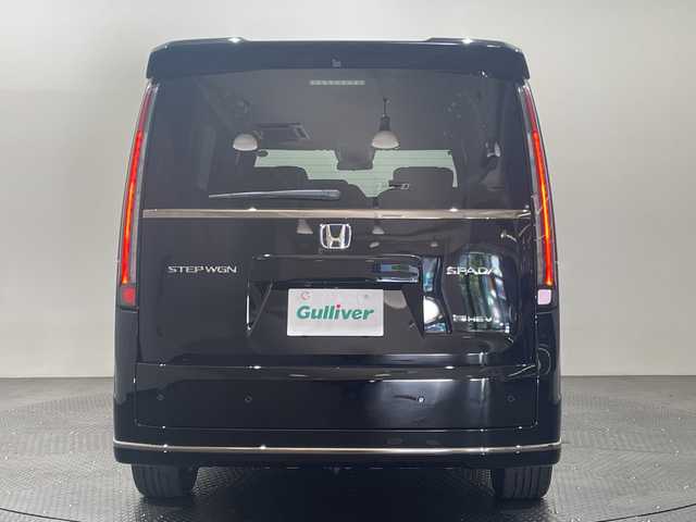 ホンダ ステップワゴン スパーダ eHEV 愛媛県 2025(令7)年 0.1千km クリスタルブラックパール 11.4インチナビHonda CONNECTナビ/Bluetooth/フルセグテレビ/バックカメラ/Honda CONNECT for Gathers/ナビ装着用スペシャルパッケージ/Honda SENSING/ブラインドスポットインフォメーション/パワーテールゲート(メモリー機能付)/2列目オットマン/ハーフレザーシート/運転席＆助手席シートヒーター/トリプルゾーンコントロール/フルオートエアコンディショナー/コンビシート/16インチアルミホイール(SPADA専用)/減速セレクター/全列USBチャージャー/LEDヘッドライト/両側パワースライドドア/スマートキー/追従型クルーズコントロール/前後コーナーセンサー