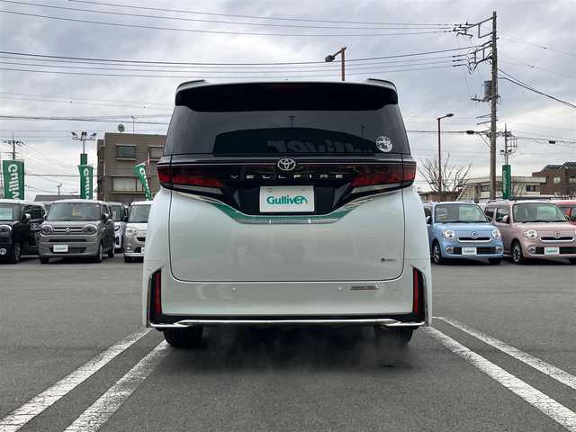 トヨタ ヴェルファイア ハイブリット Z プレミア 静岡県 2024(令6)年 0.6万km プラチナホワイトパールマイカ セキュリティーArgus/デジタルインナーミラー/エンジンスタートボタン/スマートキー（スペアキー１本）/パワーウィンドウ/パワーステアリング/MTモード付AT/100V充電/Wオートエアコン/クルーズコントロール/ETC2.0/USB入力端子/全方位カメラ/純正メーカーナビ（BT.フルセグ）/３列シート/ガラスルーフ/オットマン/電動リアゲート/ドライブレコーダー前後/ウォークスルー/フロアマット/D席N席パワーシート/D席N席セカンドシートシートヒーター/D席N席セカンドシートエアシート/両側パワースライドドア/純正アルミホイール/ABS/横滑り防止装置/コーナーセンサー前後/レーンキープアシスト/盗難防止装置/オートライト/オートマチックハイビーム/LEDライト/W+サイドエアバック/衝突軽減システム/ステアリングヒーター