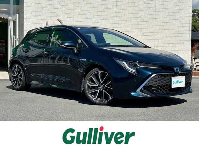 トヨタ カローラ スポーツ ハイブリッドG Z 静岡県 2019(令1)年 3.4万km ブラッキッシュアゲハガラスフレーク エンジンスタートボタン/パワーステアリング/パワーウィンドウ/アイドリングストップ/スマートキー/オートエアコン/クルーズコントロール/USB入力端子/ETC/純正ナビ/純正ドライブレコーダー/純正フロアマット/純正アルミホイール/ABS/横滑り防止装置/コーナーセンサー前後/レーンキープアシスト/盗難防止装置/オートライト/オートマチックハイビーム/LEDヘッドライト/W+サイドエアバック/カーテンエアバック/衝突軽減システム