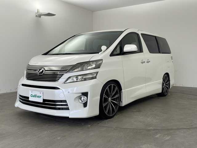 トヨタ ヴェルファイア 2．4Z Gエディション 兵庫県 2012(平24)年 5万km ホワイトパールクリスタルシャイン ・純正ナビ（TV・CD・DVD・MSV・BT）/・バックカメラ/・両側パワースライドドア/・パワーバックドア/・2列目エグゼクティブシート/・ビルトインETC/・クルーズコントロール/・純正リアフリップダウンモニター/・プレミアムサウンド/・コーナーセンサー/・フットイルミネーション/・nanoe/・AC100V電源/・純正ウッドコンビステアリング/・社外革調シートカバー/・オットマン/・前席パワーシート/・社外20インチアルミホイール/・HIDオートライト/・LEDフォグランプ/・社外車高調/・スマートキー/・スペアキー/・プッシュスタート/・社外フロアマット/・横滑り防止装置