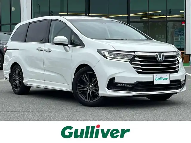 ホンダ オデッセイ ハイブリッド e:HEVアブソルート EX 奈良県 2022(令4)年 3.1万km プラチナホワイトパール 純正10インチメーカーナビ(VXU-227DYi)/(AM/FM/CD/DVD/BT/SD?USB/iPod/フルセグTV）/全方位モニター/ビルトインETC2.0/ハーフレザーシート/パワーシート/シートヒーター/シートベンチレーション/パワーバックドア/両側パワースライドドア/ドライブレコーダー/レーダークルーズコントロール/衝突軽減ブレーキ/レーントレーシングアシスト/横滑り防止装置/オートライト/革巻きステアリング/ステアリングスイッチ/純正フロアマット/電格ウインカーミラー/スペアキー/電動サイドブレーキ