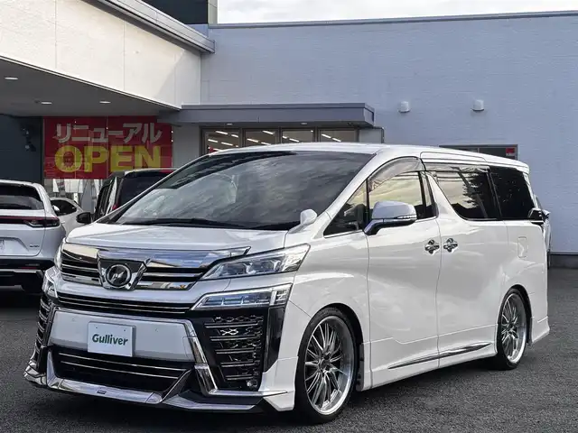 トヨタ ヴェルファイア Z Gエディション 熊本県 2018(平30)年 6.2万km ホワイトパールクリスタルシャイン モデリスタフルエアロ/DORFREN21インチAW/純正10インチナビ（NSZN-Z68T）/【フルセグTV/Bluetooth/CD/DVD】/バックカメラ/フリップダウンモニター/両側パワースライドドア/レーダークルーズコントロール/プリクラッシュセーフティー/レーントレーシングアシスト/クリアランスソナー/パーキングサポートブレーキ/ロードサインアシスト/デジタルインナーミラー/パワーバックドア/オートLEDヘッドライト/オートハイビーム/ウィンカーミラー/ブレーキホールド/1/2列目パワーシート/N席/2列目オットマン/前席シートヒーター/エアシート/ステアリングヒーター/ステアリングスイッチ/ドライブレコーダー前後/ビルトインETC/純正フロアマット/純正ドアバイザー/プッシュスタート/スマートキー/横滑り防止装置/保証書/スペアキー