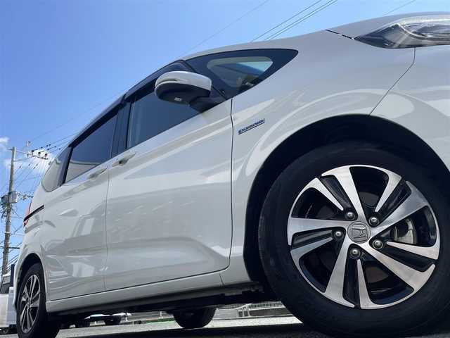 ホンダ フリード＋ ハイブリット EX 熊本県 2018(平30)年 6.8万km ホワイトオーキッドパール 純正9インチナビ（VXM-187VFNi）/【フルセグTV/Bluetooth再生/CD/DVD】/バックカメラ/両側パワースライドドア/アダプティブクルーズコントロール/車線維持支援システム/路外逸脱抑制システム/衝突軽減ブレーキ/LEDオートライト/フォグライト/ハーフレザーシート/ビルトインETC/ドライブレコーダー/保証書/取扱説明書