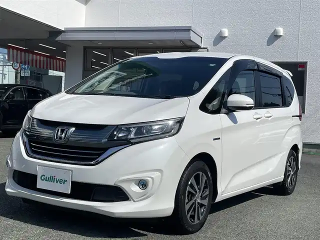 ホンダ フリード＋ ハイブリット EX 熊本県 2018(平30)年 6.8万km ホワイトオーキッドパール 純正9インチナビ（VXM-187VFNi）/【フルセグTV/Bluetooth再生/CD/DVD】/バックカメラ/両側パワースライドドア/アダプティブクルーズコントロール/車線維持支援システム/路外逸脱抑制システム/衝突軽減ブレーキ/LEDオートライト/フォグライト/ハーフレザーシート/ビルトインETC/ドライブレコーダー/保証書/取扱説明書