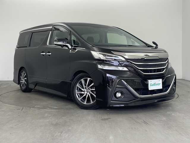 トヨタ ヴェルファイア ZA Gエディション 兵庫県 2015(平27)年 5.6万km バーニングブラッククリスタルシャインガラスフレーク ・純正ナビ/TV/Bluetooth/CD/DVD/SD/・全方位カメラ/・レーンキープアシスト/・横滑り防止装置/・前後コーナーセンサー/・クルーズコントロール/・両側パワースライドドア/・パワーバックドア/・ハーフレザーシート/・エグゼクティブシート/・ステアリングヒーター/・スマートキー/・ビルトインETC/・社外前方ドライブレコーダー/・nanoe/・メモリシート/・パワーシート/・オートマチックハイビーム/・ウッドコンビステアリング/・純正フロアマット/・フットイルミネーション/・オットマン/・社外シーケンシャルウインカー/・モデリスタエアロ/・社外車高調/・社外リアリフレクター/・純正17インチアルミホイール/・LEDオートライト/・LEDフォグランプ/・取扱説明書